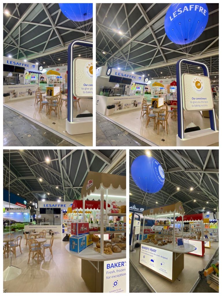 A montage of four views showing white product display stands and blue overhead signage.